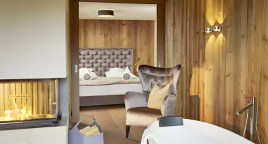 Sporthotel Ellmau in Ellmau – Luxuriöses Badezimmer mit Kamin und Badewanne | Wellnesshotel Tirol