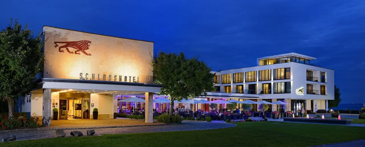 Schlosshotel Bad Wilhelmshöhe in Kassel – Hotelaußenansicht bei Nacht mit beleuchteter Terrasse und Restaurant | Wellnesshotel Hessen