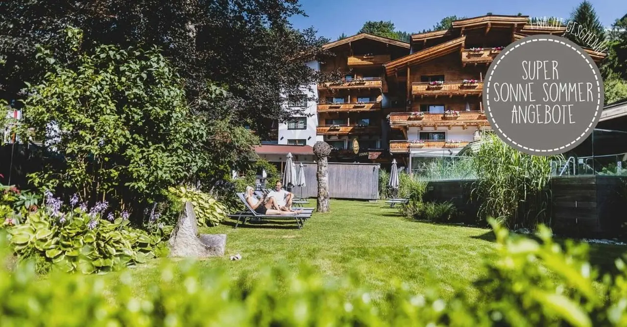 ALL INCLUSIVE Hotel DIE SONNE in Saalbach – Hotelgarten mit Liegewiese und Gästen | Wellnesshotel Salzburg
