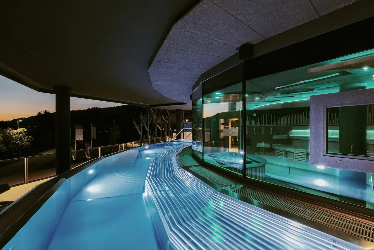Wellness & Naturhotel Tonihof**** in Langdorf – Beleuchteter Außenpool bei Sonnenuntergang | Wellnesshotel Bayerischer Wald