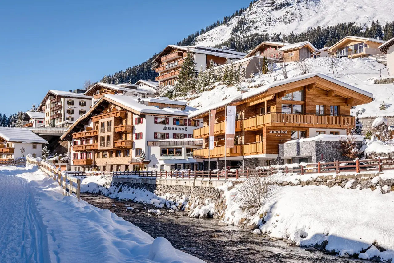 Hotel Auenhof in Lech am Arlberg – Traditionelles Hotelgebäude im Winter mit Schnee | Wellnesshotel Arlberg