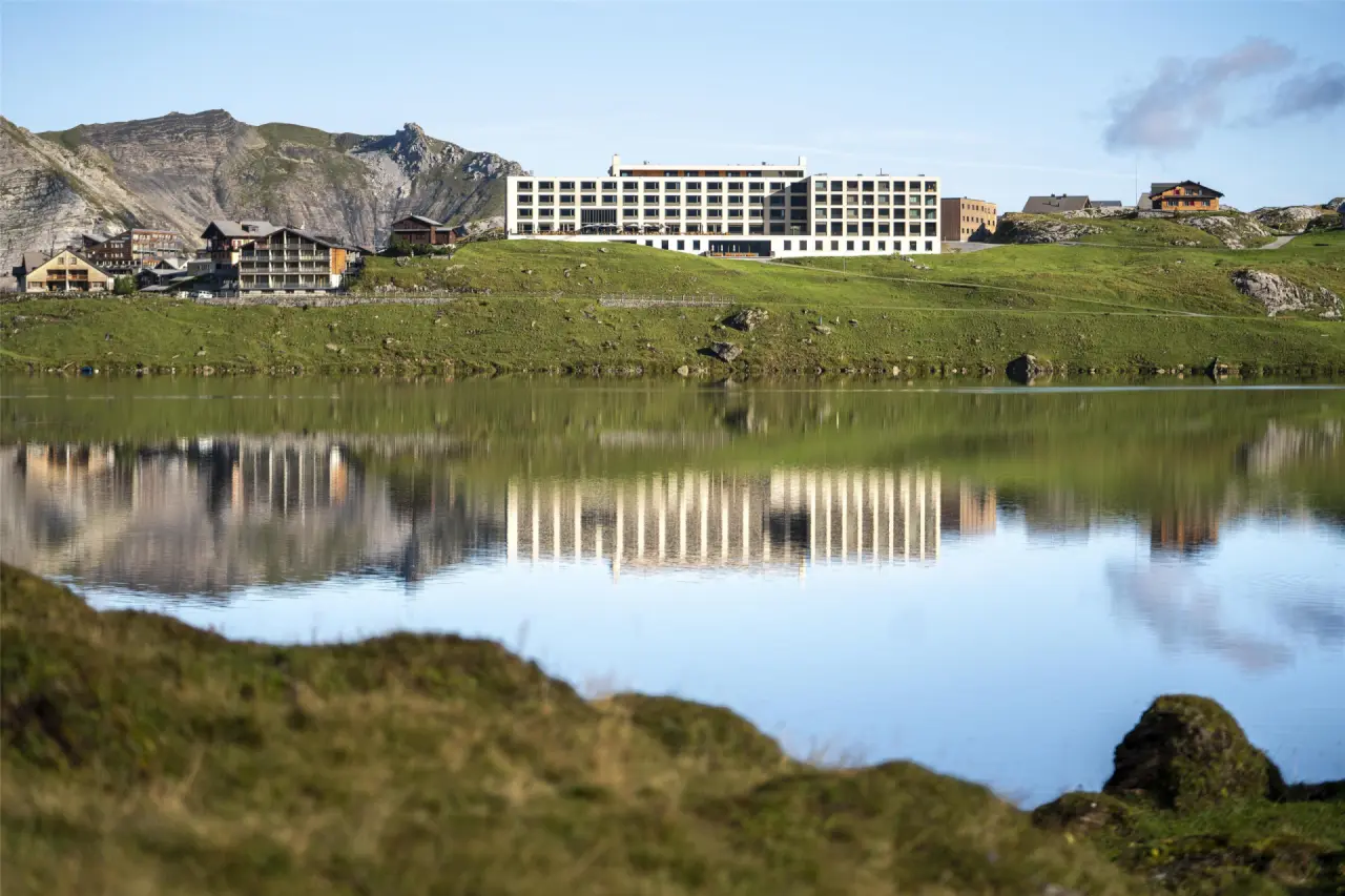 Frutt Mountain Resort in Kerns – Hotelgebäude am Bergsee mit Spiegelung | Wellnesshotel Zentralschweiz