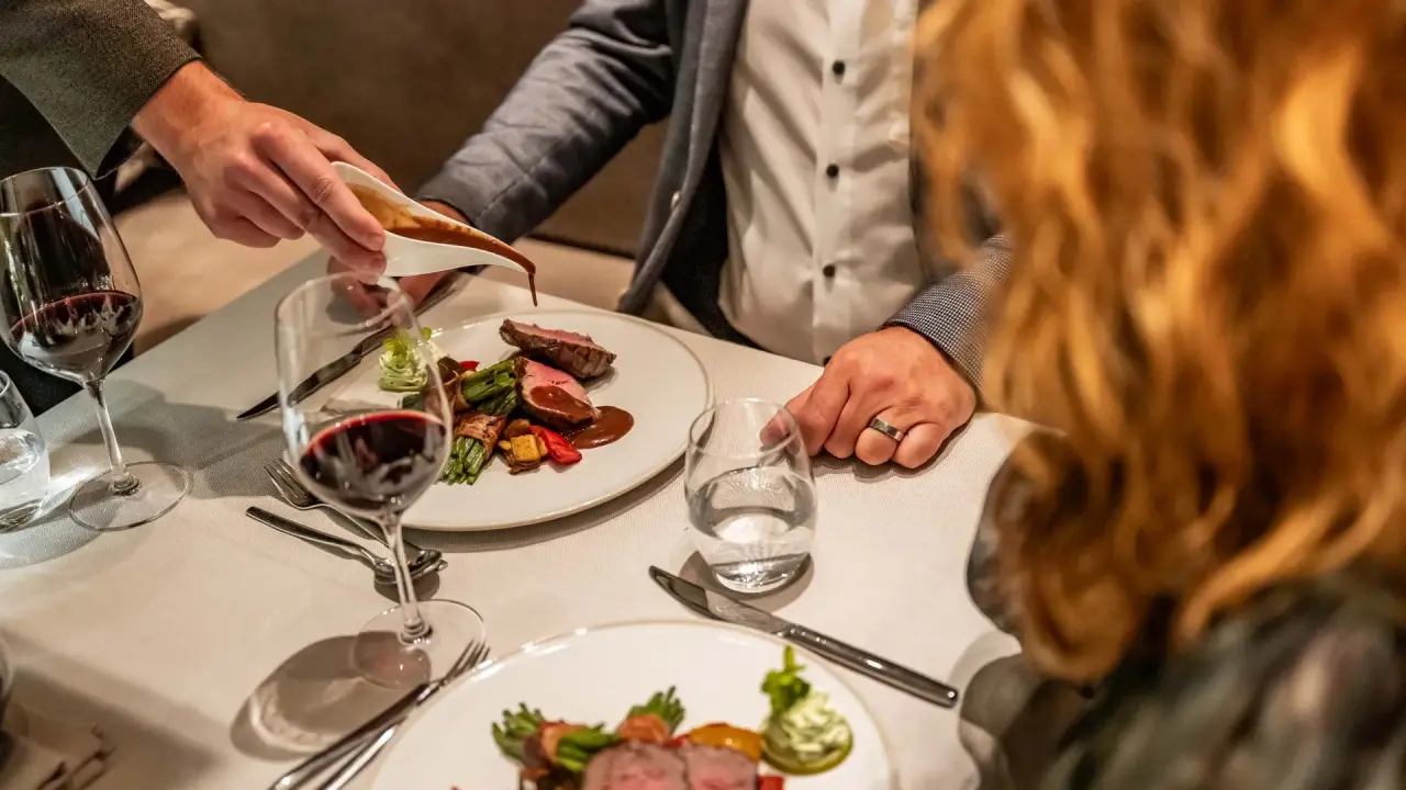 La Val Hotel & Spa in Brigels – Exquisites Abendessen wird im Hotelrestaurant serviert | Wellnesshotel Graubünden