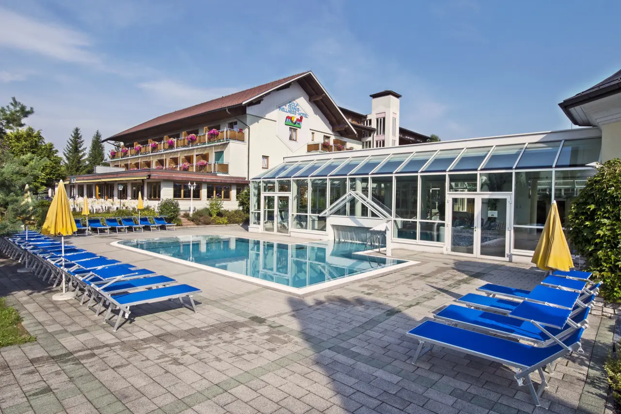 Golf-Tennis-Wellnesshotel Mori in St. Kanzian – Außenpool mit Liegen und Hotelgebäude | Wellnesshotel Kärnten