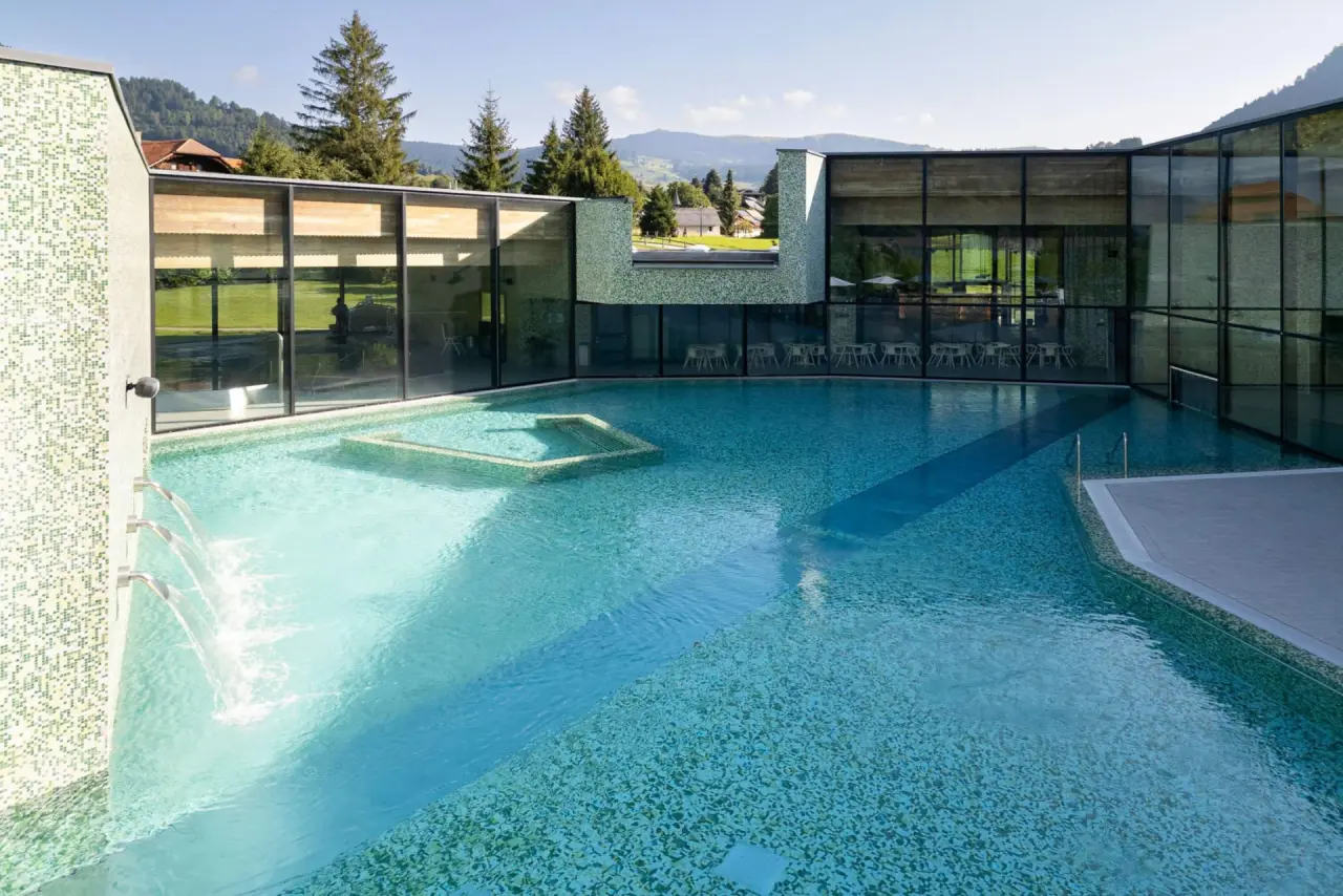 Hotel Cailler in Val-de-Charmey – Moderner Innen- und Außenpoolbereich mit Bergblick | Wellnesshotel Fribourg