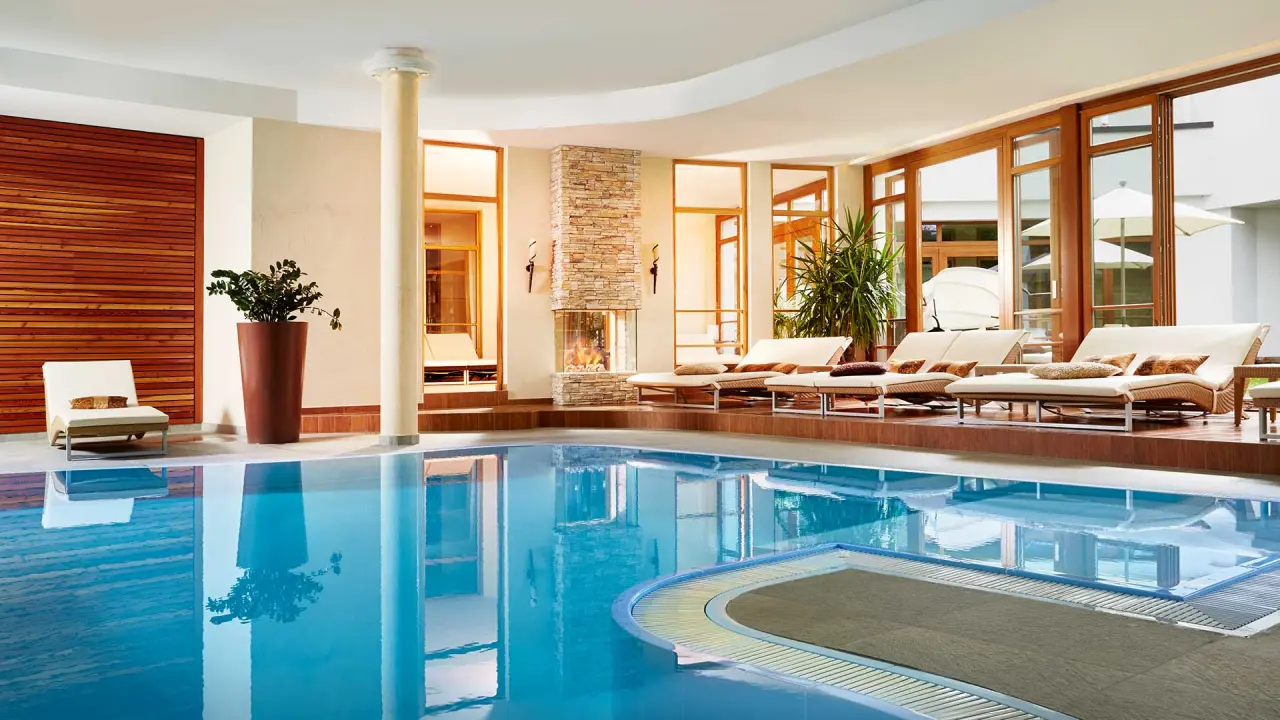 Alpine Hotel Resort Goies in Ladis – Heller Innenpoolbereich mit Kamin und Liegemöglichkeiten | Wellnesshotel Tirol