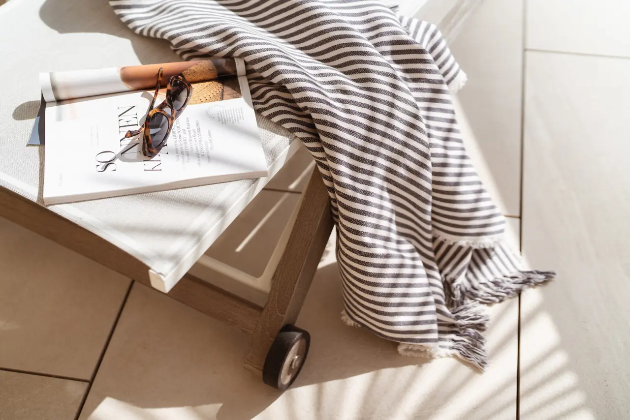 Hotel Eden Roc Ascona in Ascona – Sonnenliege mit Decke, Sonnenbrille und Magazin | Wellnesshotel Ascona