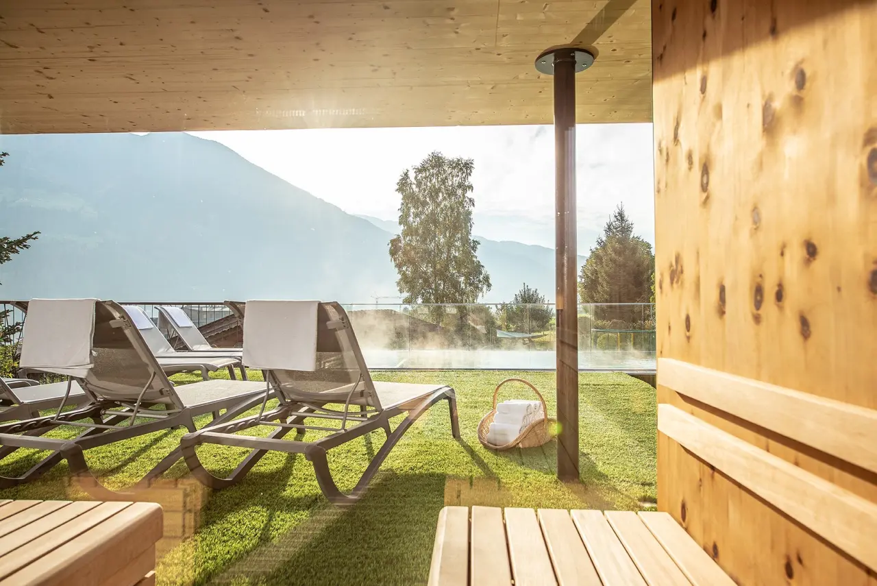 Gardenhotel Crystal in Fügen – Entspannungsbereich im Freien mit Bergblick und Liegestühlen | Wellnesshotel Zillertal