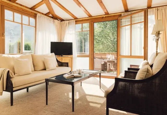 ALPENPALACE Luxury Hideaway & Spa Retreat in Luttach – Helles Wohnzimmer mit großen Fenstern und Balkon | Wellnesshotel Ahrntal