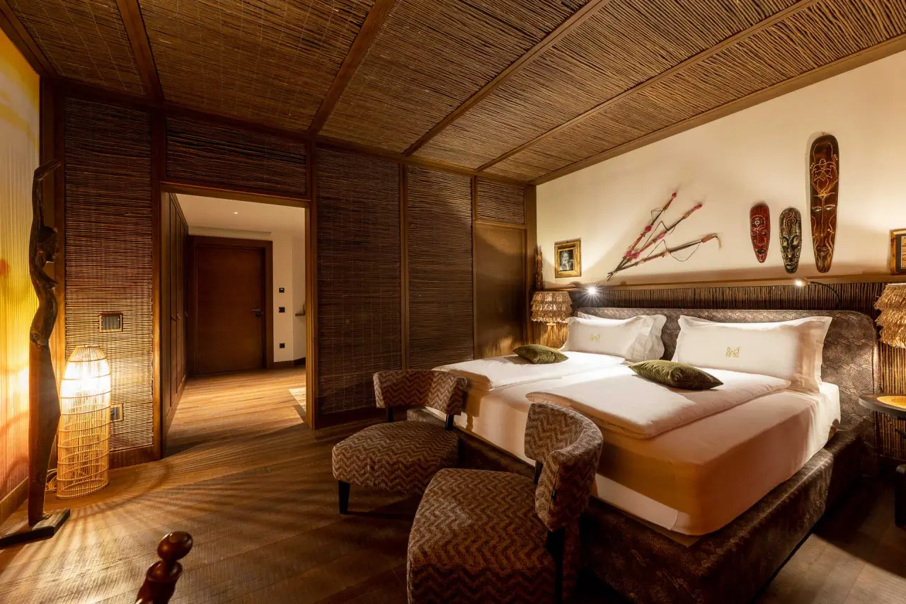 Manna Resort in Bozen – Afrikanisch inspiriertes Zimmer mit Holzwänden und Dekoration | Wellnesshotel Südtirol