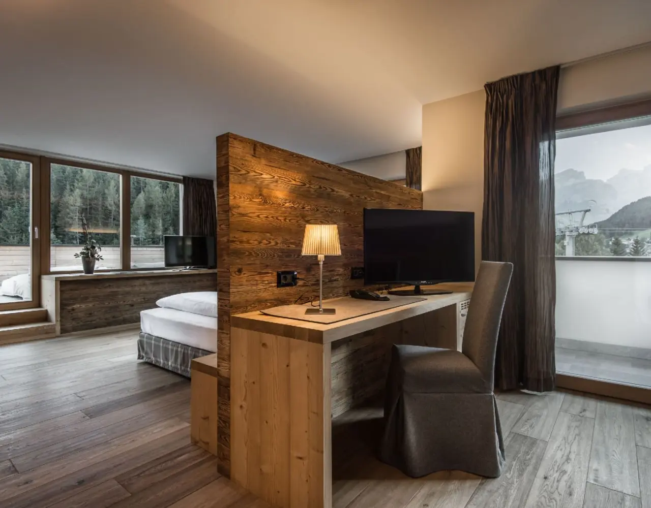 Hotel Christiania in La Villa – Hotelzimmer mit Schreibtisch und Balkonblick auf die Berge | Wellnesshotel Dolomiten