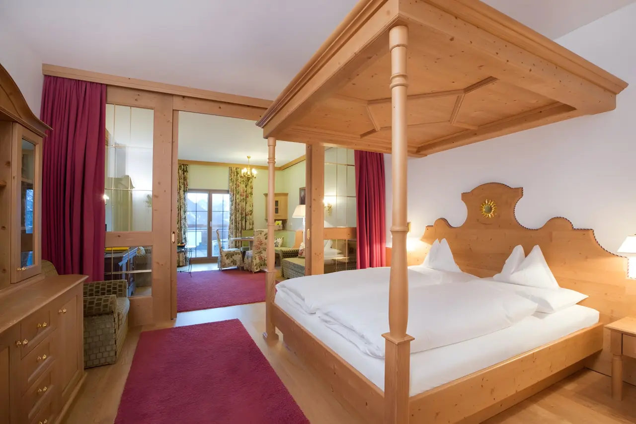 Hotel Sonnenburg in Lech am Arlberg – Traditionelles Zimmer mit Himmelbett und separatem Wohnbereich | Wellnesshotel Arlberg