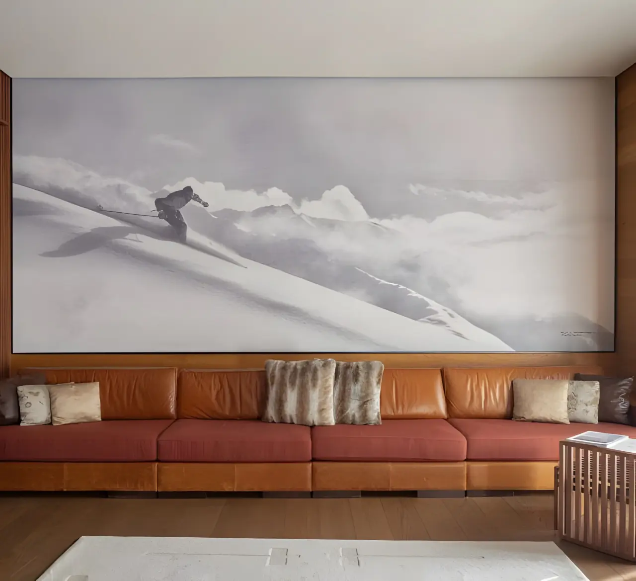 The Chedi Andermatt in Andermatt – Geräumiger Wohnbereich mit Skifahrer-Wandbild | Wellnesshotel Schweizer Alpen