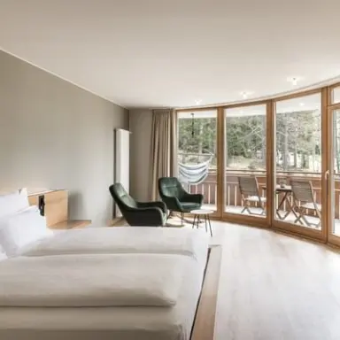 Falkensteiner Hotel Antholz in St. Martin in Gsies – Luxuriöses Zimmer mit Panoramafenster und Hängematte | Wellnesshotel Südtirol